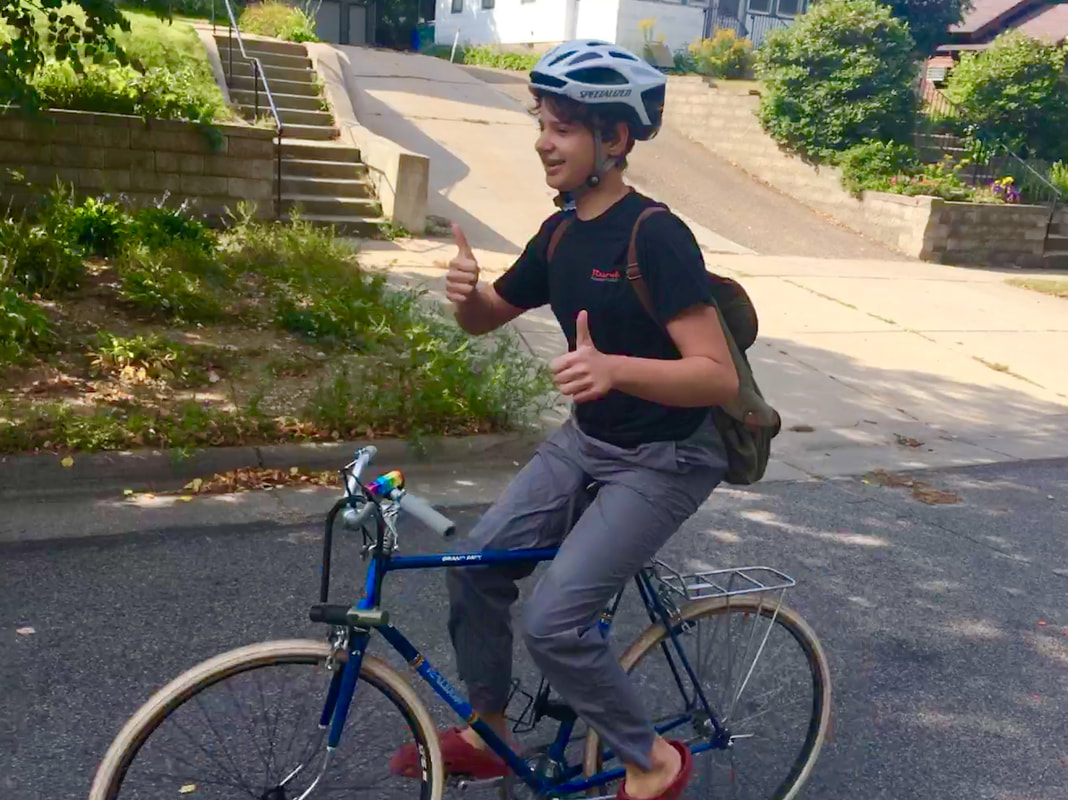 Ada riding her bicycle no handed